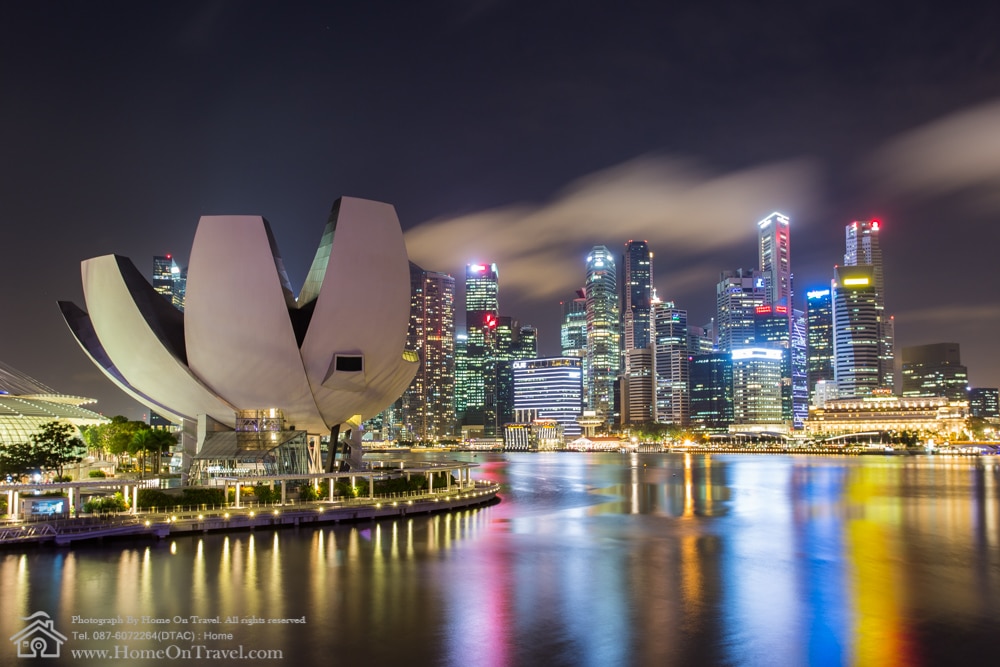 Home On Travel - ArtScience Museum in Singapore with Central business district on background at night.