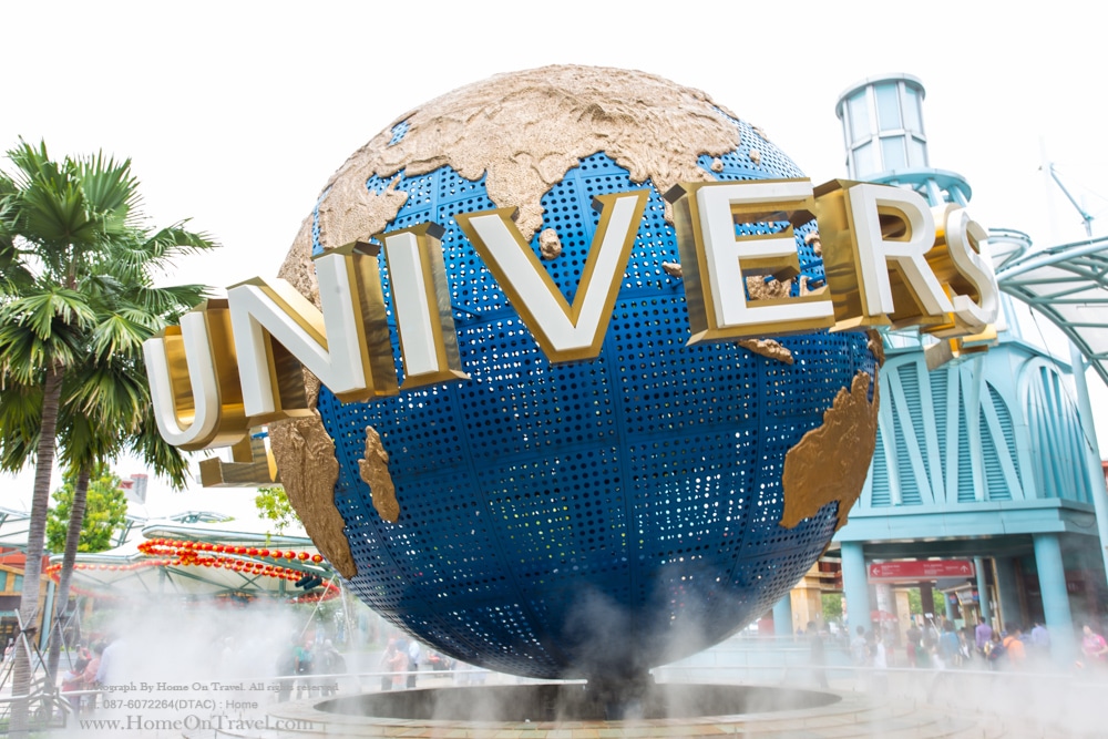 Home On Travel - Tourists and theme park visitors taking pictures of the large rotating globe fountain in front of Universal Studios in Sentosa island, Singapore